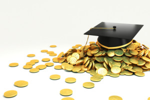 college graduate hat over gold coin